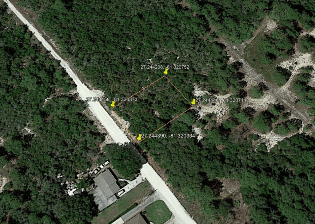 Aerial view of a wooded lot outlined in orange with four corner pins and GPS coordinates at each corner.