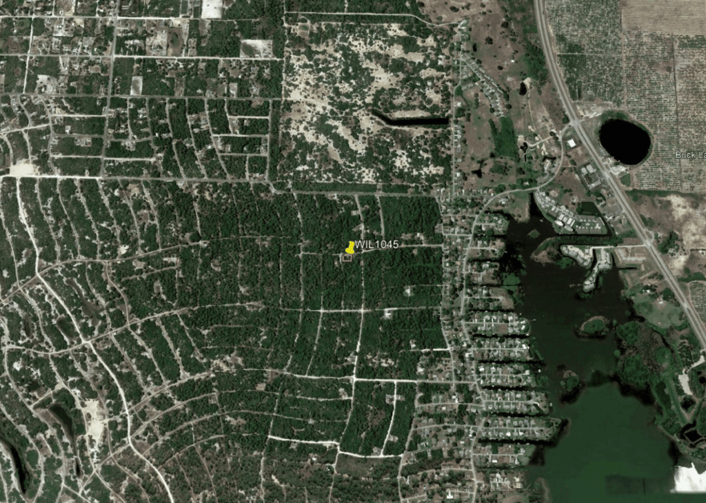 Satellite map showing a coastal town with grid streets and a highlighted location labeled WIL1045 near the center.