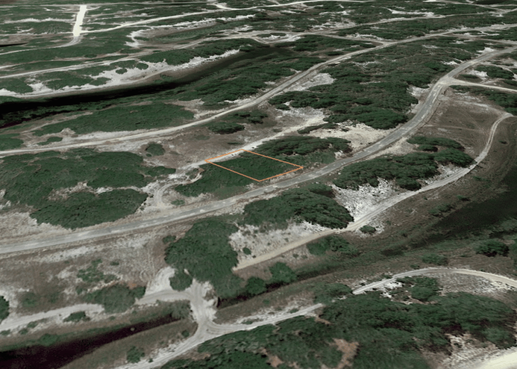 Aerial view of a shrub-covered hillside with winding dirt roads and an orange-outlined rectangular land parcel.