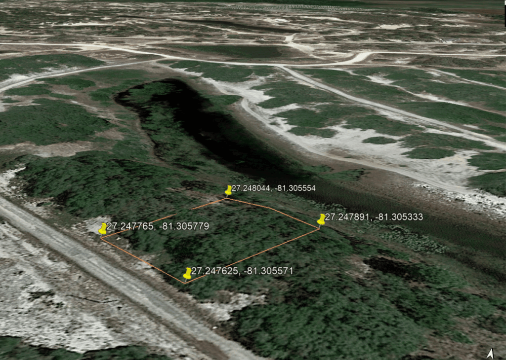 Aerial view of a small rectangular plot outlined in orange with four GPS pins at about 27.2476, -81.3056 in a marshy green landscape.